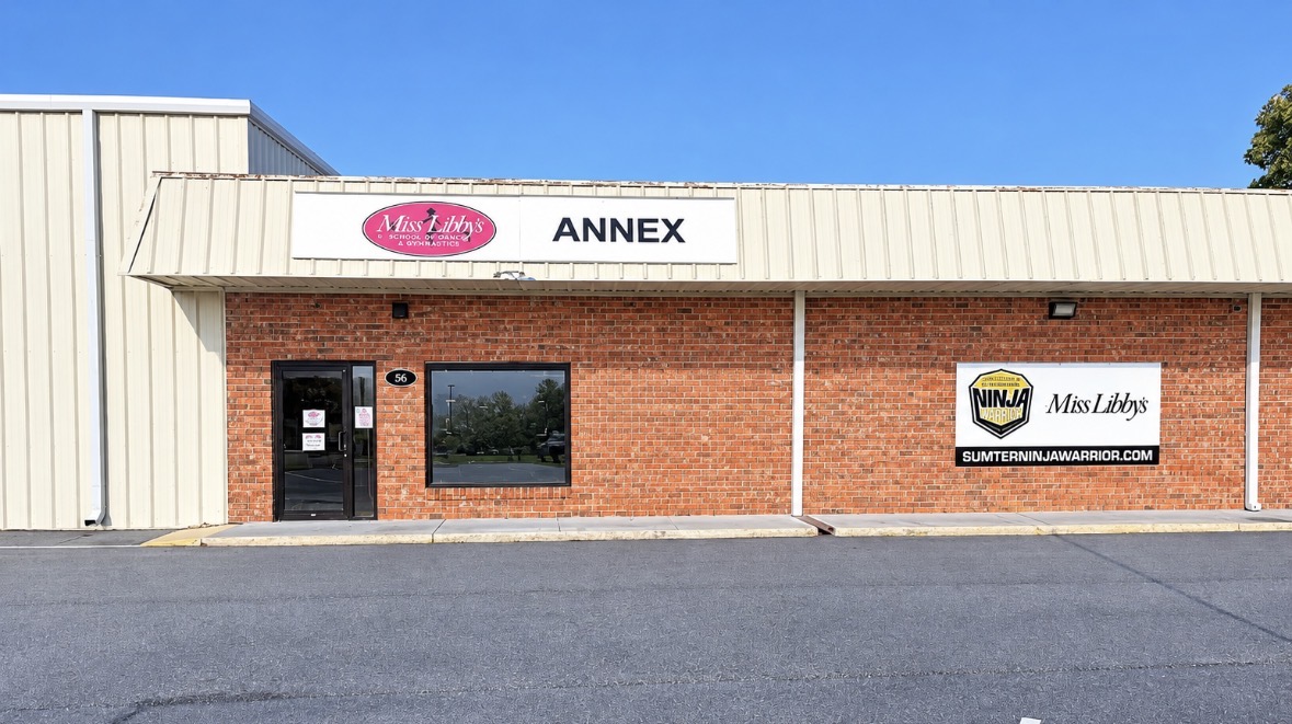 Front of the Miss Libby's Annex on Market Street showing the Miss Libby's School of Dance and Gymnastics Annex sign and the Sumter Ninja Warrior banner